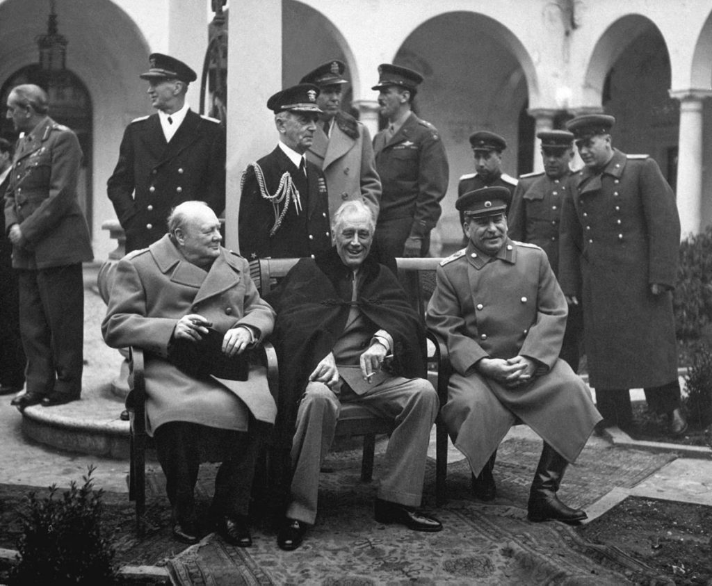 Churchill, FDR, and Stalin sit together at the Yalta Conference.