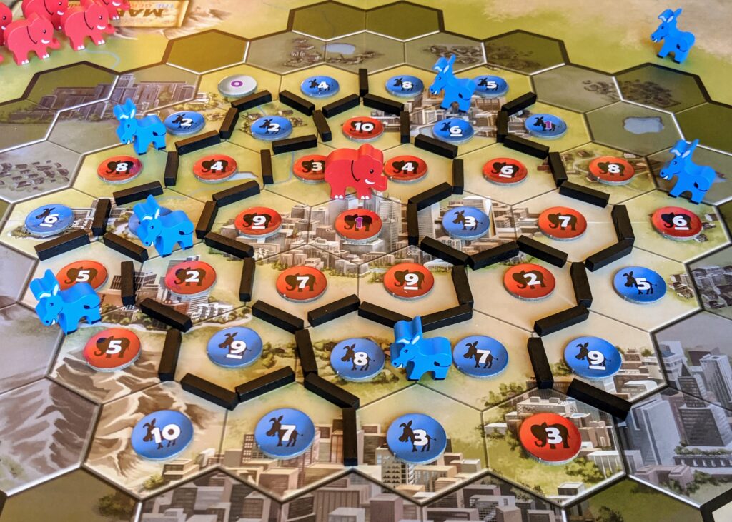 The end of a solo game of Mapmaker, with six blue districts and one red district.