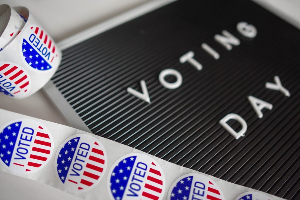 "I Voted" stickers and a sign that says "Voting Day." Given students an opportunity to participate in simulations of the democratic process, like a mock election.