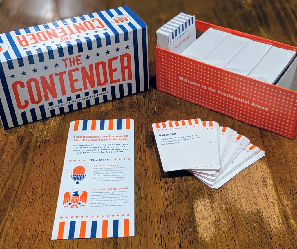 Contents of the game, The Contender, including a box, the instructions, the topic cards, and the argument cards.