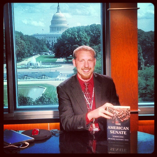 Brian Rock sitting at the Washington Journal desk while working as a C-SPAN Teacher Fellow