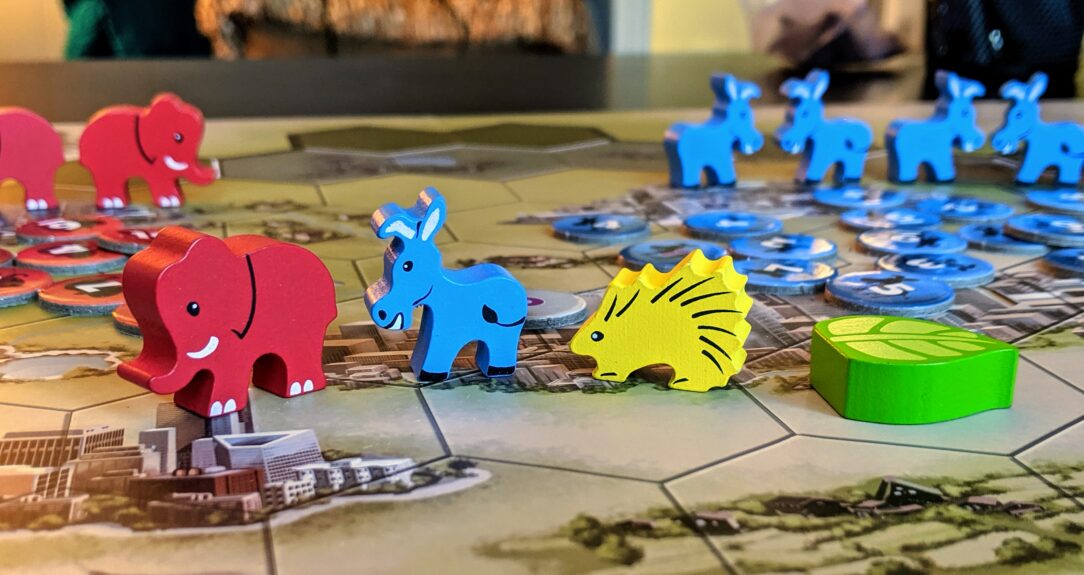 Close up view of the four game pieces from Mapmaker: the Gerrymanderin game.